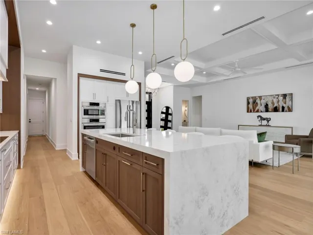 Center Island with Solid Oak Cabinets and quartz waterfall countertop and under cabinet floor lighting