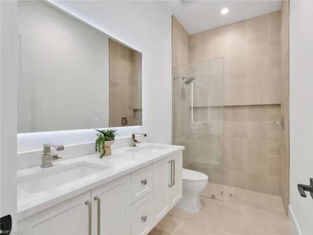 Shared 2nd Full Bath, quartz counters/double sink and floating vanity with under-mount lighting