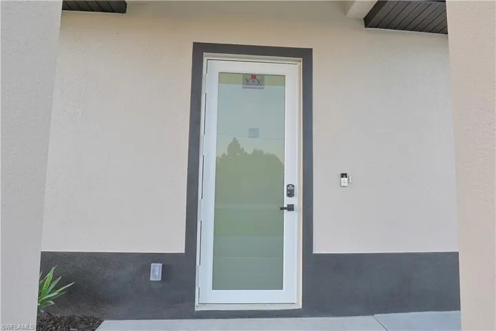 Entrance to property featuring stucco siding
