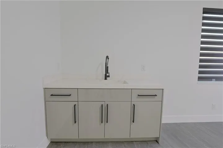 Detailed view of baseboards and a sink