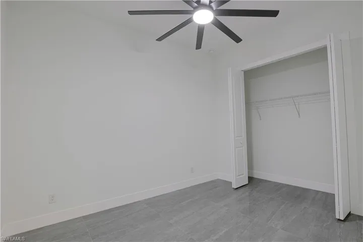 Unfurnished bedroom featuring a closet and a ceiling fan