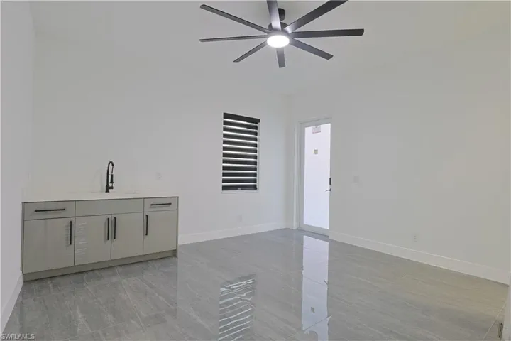 Spare room featuring baseboards and ceiling fan