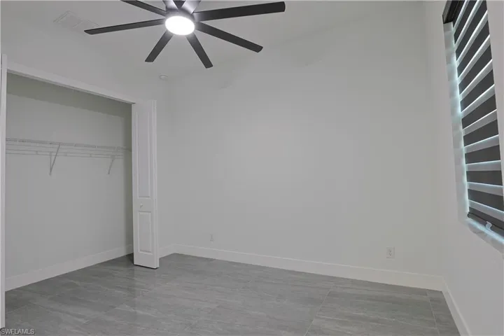 Unfurnished bedroom with a closet and ceiling fan
