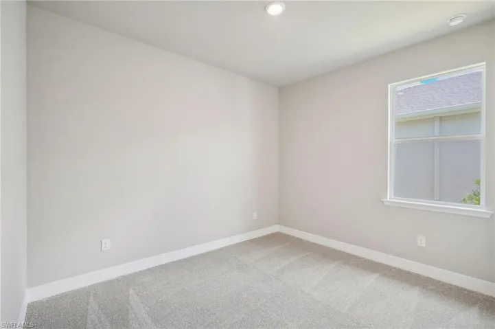 Spare room featuring carpet