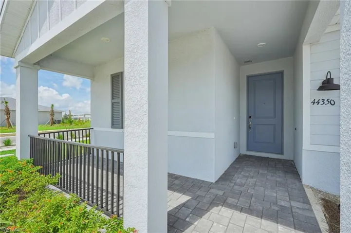 Entrance to property featuring covered porch