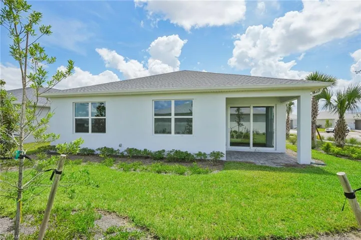 Rear view of house featuring a lawn