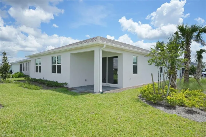 Rear view of property featuring a patio and a yard