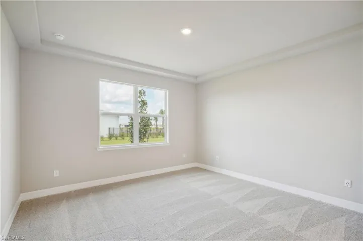 Empty room featuring light carpet