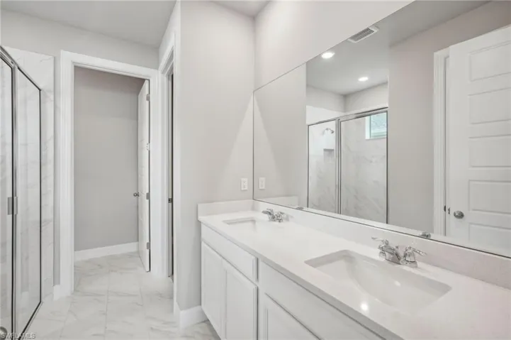 Bathroom with vanity and an enclosed shower