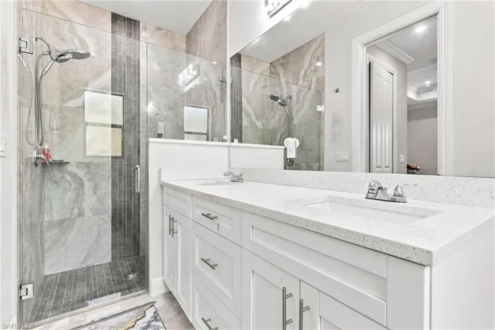 Dual vanity with white cabinetry and integrated sinks