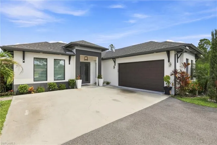 Contemporary exterior with white stucco finish and dark grey accents