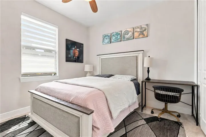 Window with horizontal blinds, overhead ceiling fan, and light-toned wall finishes