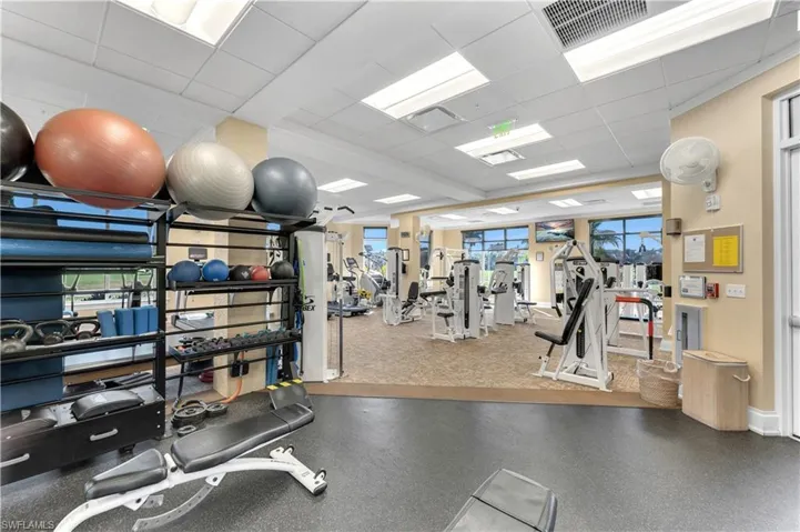 Exercise room featuring visible vents and a drop ceiling