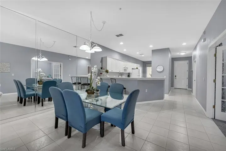 Dining area featuring an inviting chandelier, light tile patterned floors, recessed lighting, and visible vents