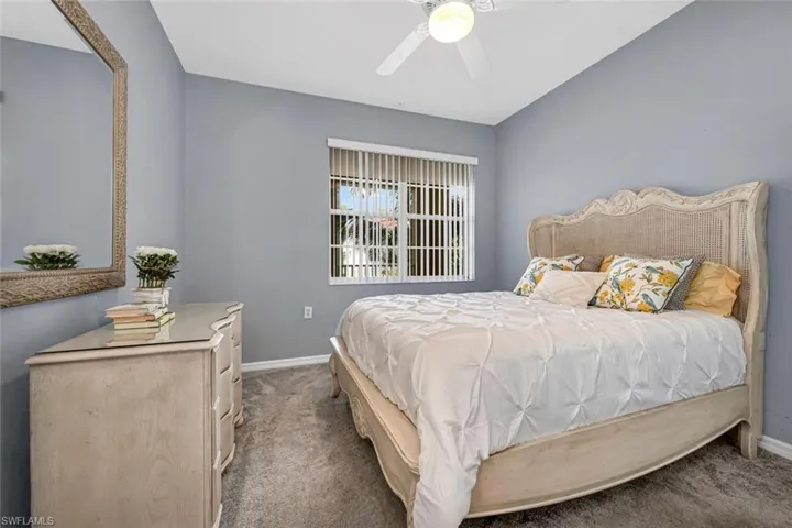 Bedroom featuring baseboards, ceiling fan, and carpet flooring