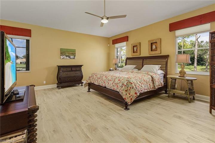 Den features a murphy bed, new floors, crown molding, plantation shutters.