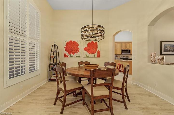 Formal dining area with new floors and plantation shutters.
