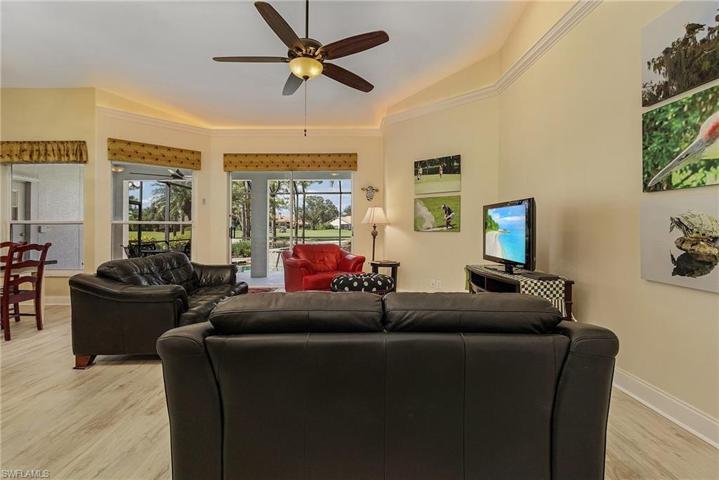 Great room has sliders out to the screened lanai.