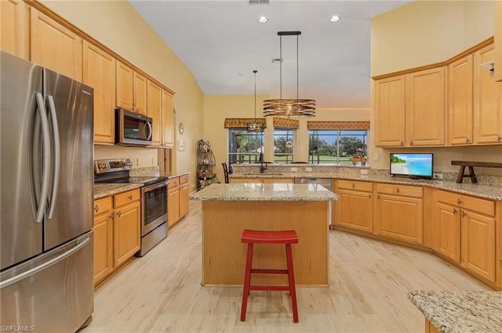 Kitchen has prep island, plenty of counter and cabinet space.