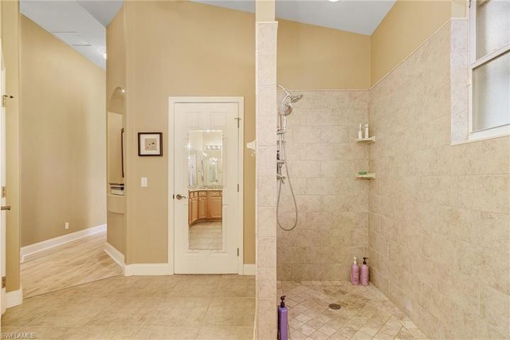 Master bath has dual sinks, sit down vanity, walk-in shower, tile floors.