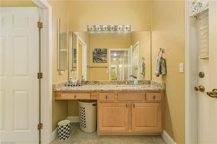 Very spacious guest bedroom with plantation shutters, new floors, lighted ceiling fan.