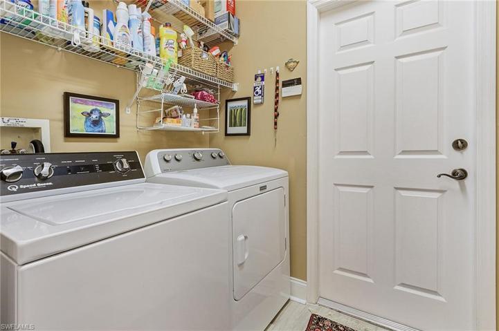 Guest bath with tub and shower combo, granite tops, tile floor.