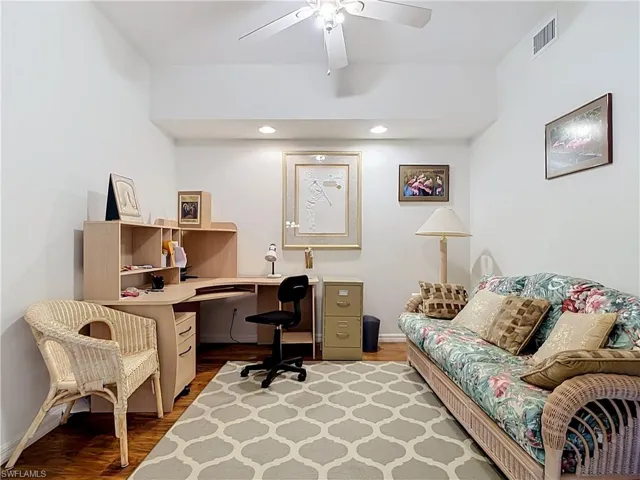 Wood-finish flooring with recessed lighting and ceiling fan