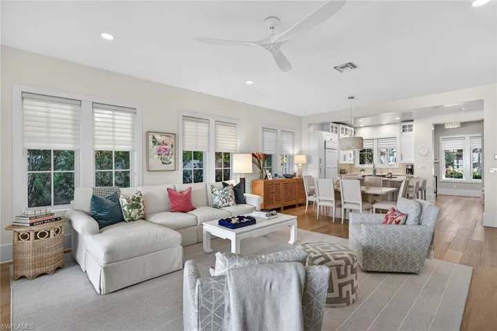Living area with light wood-type flooring, ceiling fan, and recessed lighting