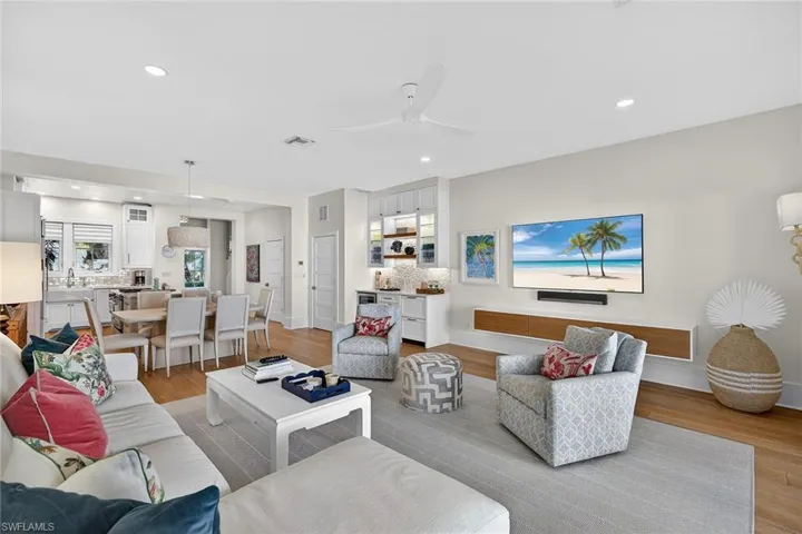 Living area featuring light wood-type flooring, ceiling fan, wine cooler, and recessed lighting