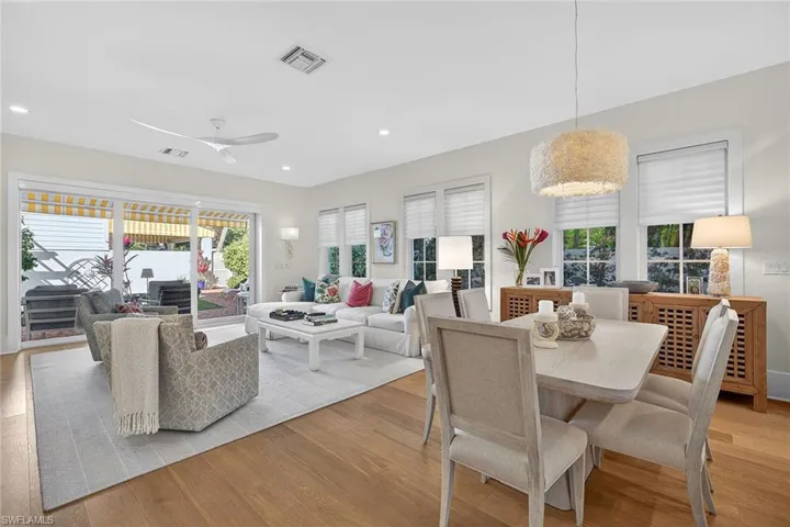 Dining area with light wood-style floors, ceiling fan, plenty of natural light, and recessed lighting