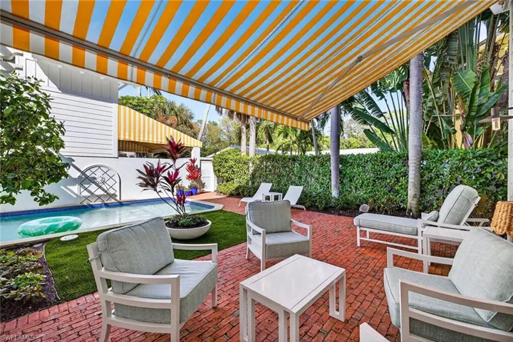 Fenced backyard with a patio area, a pergola, an outdoor lounge area, and a hot tub