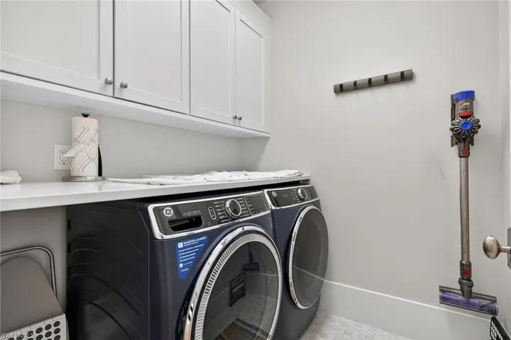 Laundry room with cabinet space and independent washer and dryer