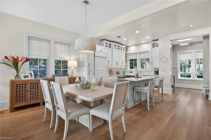 Dining space with dark wood-style flooring and recessed lighting