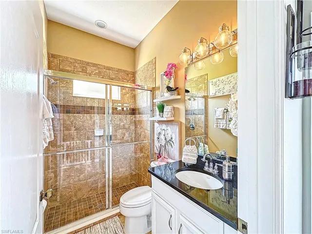 Bathroom with vanity and a shower stall