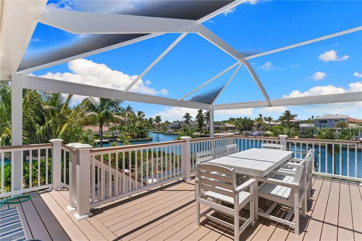 Expansive outdoor deck featuring composite decking and a screened-in enclosure