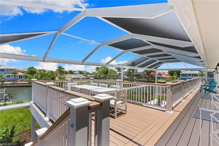 Expansive screened deck featuring composite decking and a white railing system