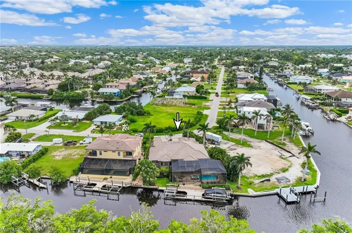 Aerial perspective of suburban area featuring a nearby body of water