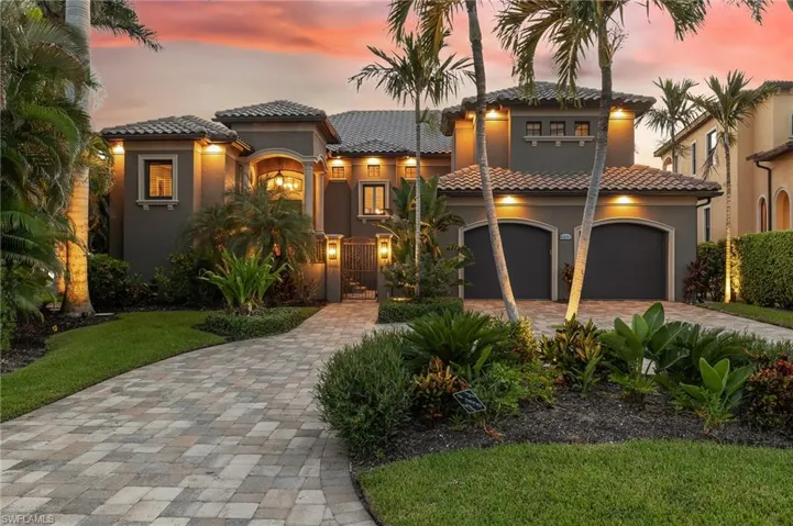 Mediterranean / spanish home with stucco siding, decorative driveway, a garage, and a tile roof