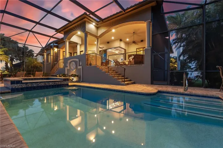 View of pool featuring stairway, glass enclosure, a patio area, and a ceiling fan