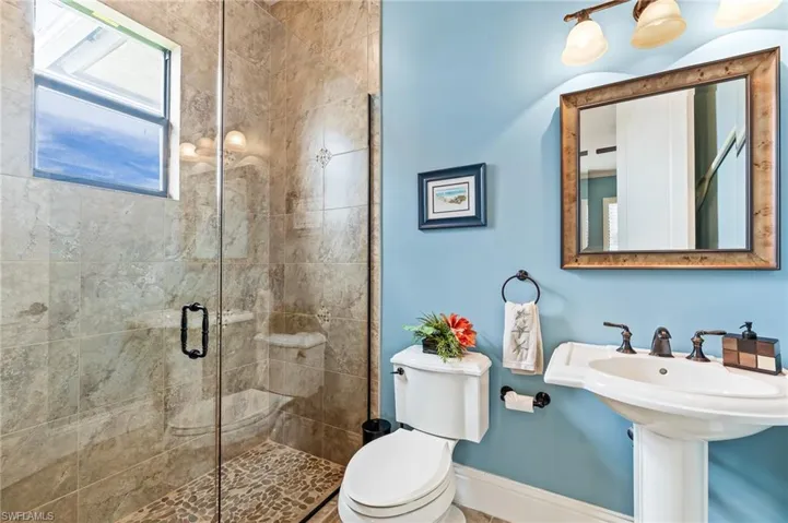 Full bath featuring a stall shower and toilet