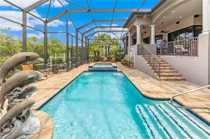 View of swimming pool featuring a patio, stairs, a ceiling fan, a sunroom, and glass enclosure