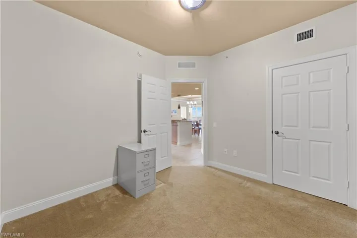 Unfurnished bedroom featuring light colored carpet