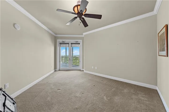 Spare room featuring ceiling fan, french doors, crown molding, and carpet flooring