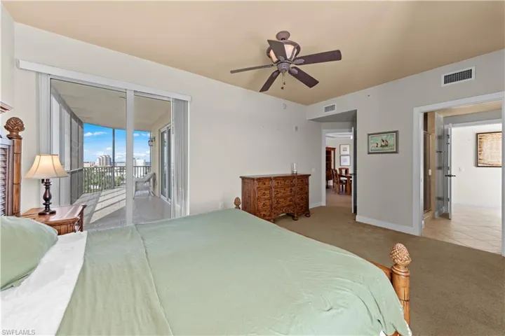 Bedroom featuring tile floors, ceiling fan, and access to outside