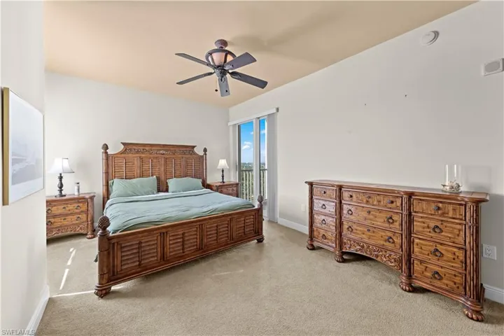 Carpeted bedroom with ceiling fan