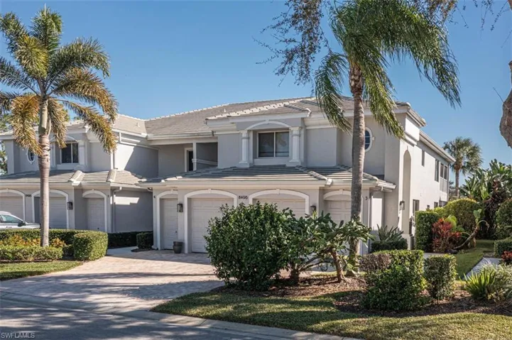 Mediterranean / spanish house with decorative driveway, stucco siding, a tile roof, and a garage