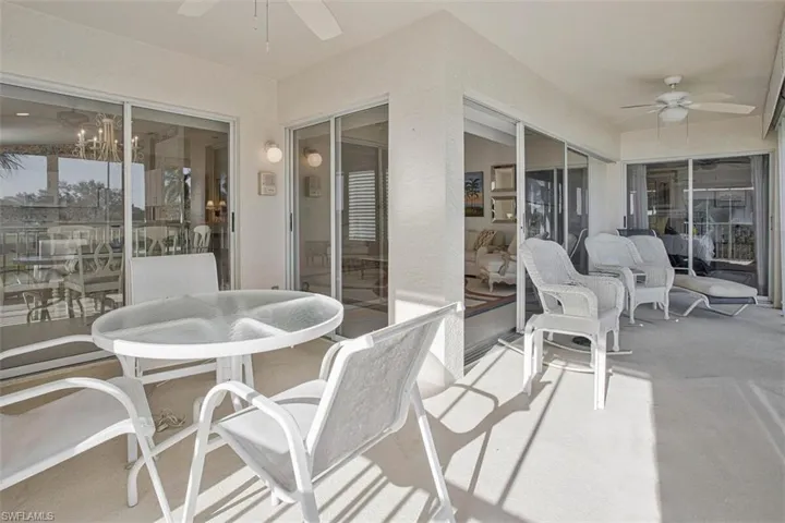 Sunroom / solarium featuring a ceiling fan, outdoor dining space, and a patio area
