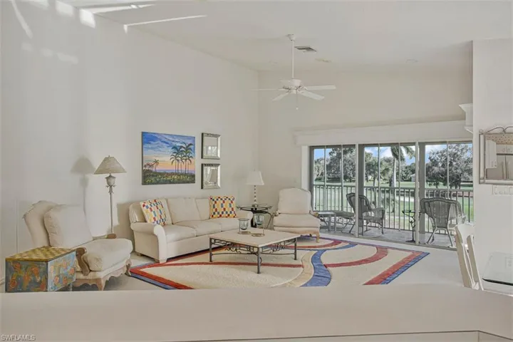 Living area with a high ceiling and a ceiling fan