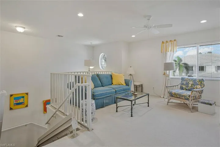 Living room featuring carpet floors, ceiling fan, and recessed lighting
