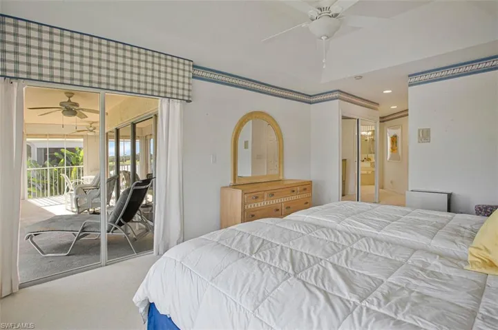 Carpeted bedroom with a ceiling fan, access to outside, recessed lighting, a closet, and a sunroom